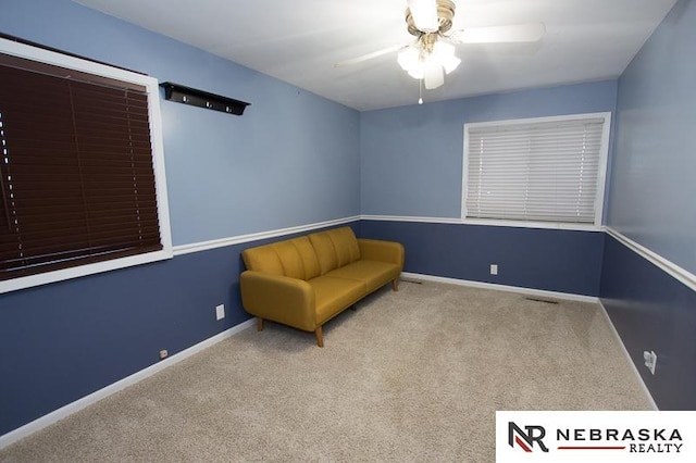 unfurnished room with light colored carpet and ceiling fan