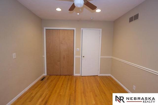 unfurnished bedroom featuring a closet, ceiling fan, and light wood-type flooring