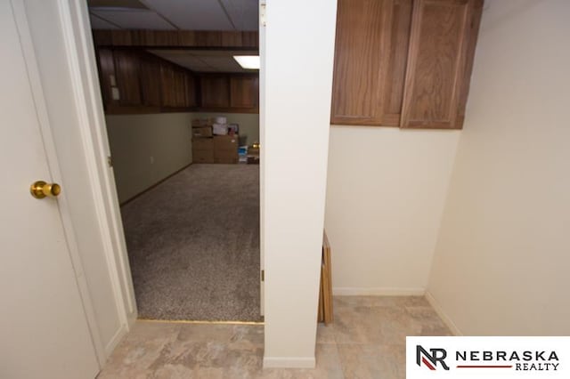 clothes washing area featuring light colored carpet