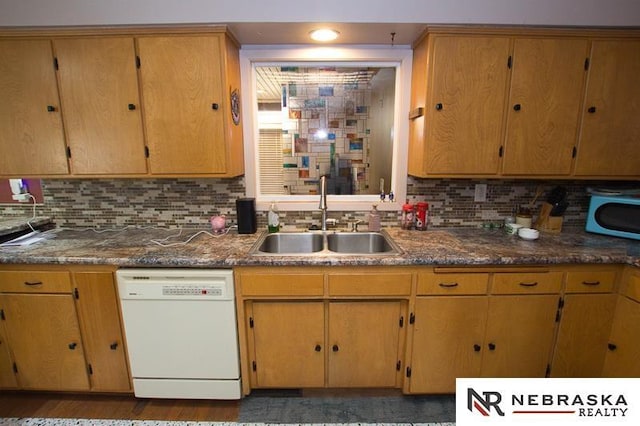 kitchen featuring sink, backsplash, and dishwasher