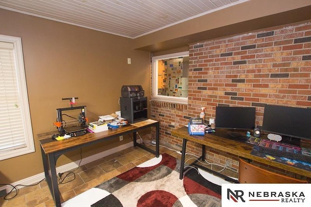 office area with ornamental molding, brick wall, and light tile patterned floors