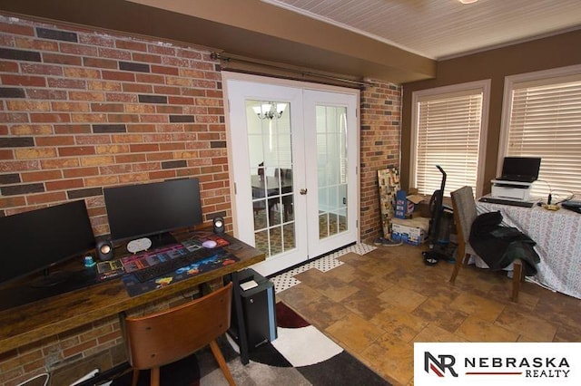 office space with french doors, brick wall, and a notable chandelier