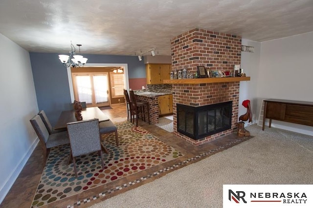 living room with an inviting chandelier and a fireplace