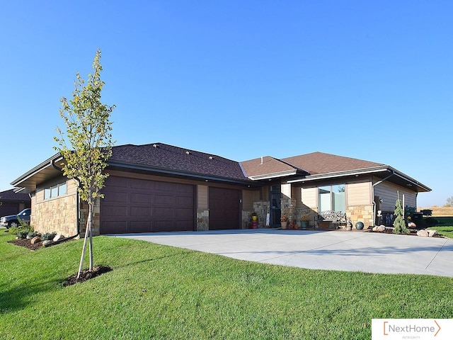 prairie-style house featuring a front yard and a garage