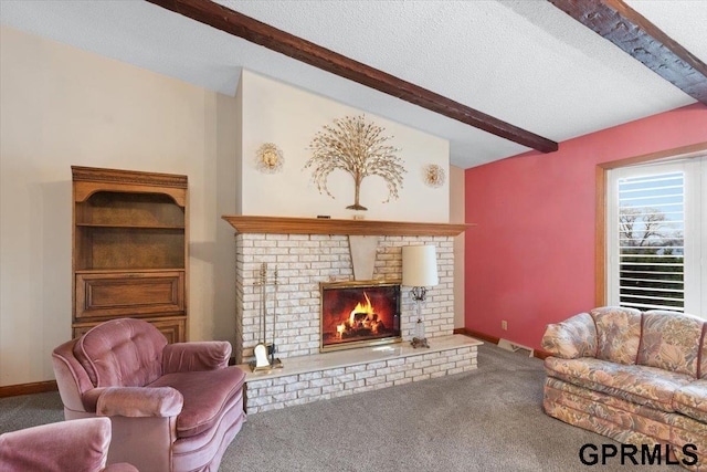 carpeted living room featuring a fireplace, beam ceiling, and a textured ceiling