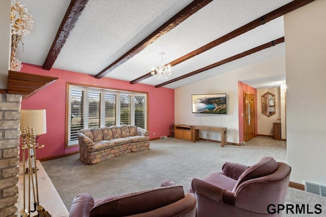 carpeted living room featuring a chandelier, lofted ceiling with beams, and a textured ceiling