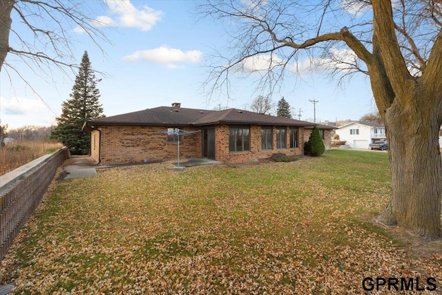 rear view of property with a lawn