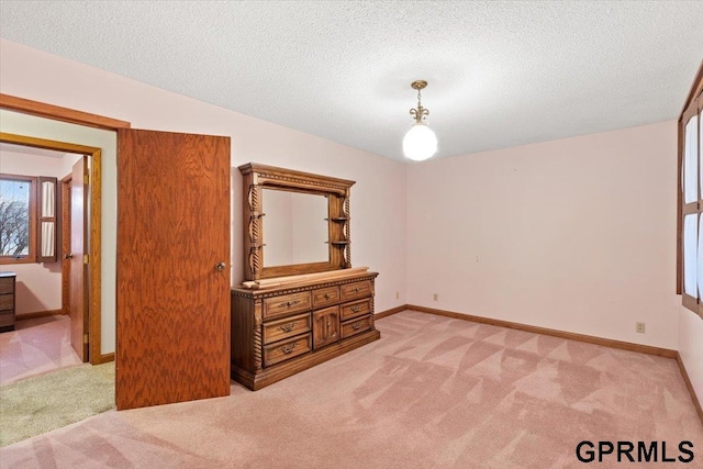 carpeted spare room with a textured ceiling