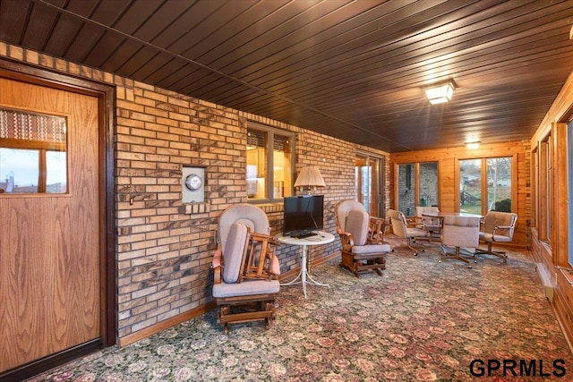 unfurnished room with wood walls and brick wall