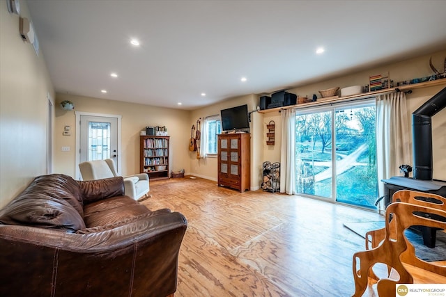 living room featuring light wood-type flooring and a wealth of natural light