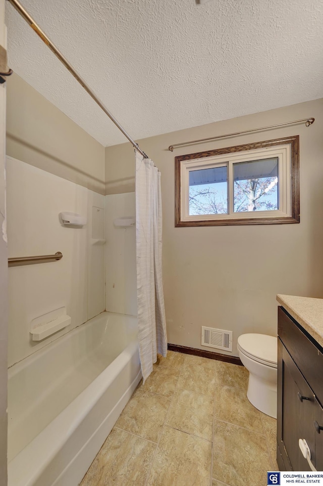 full bathroom with shower / tub combo with curtain, vanity, a textured ceiling, and toilet