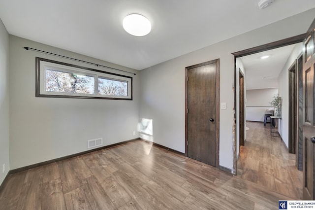 unfurnished bedroom featuring hardwood / wood-style flooring