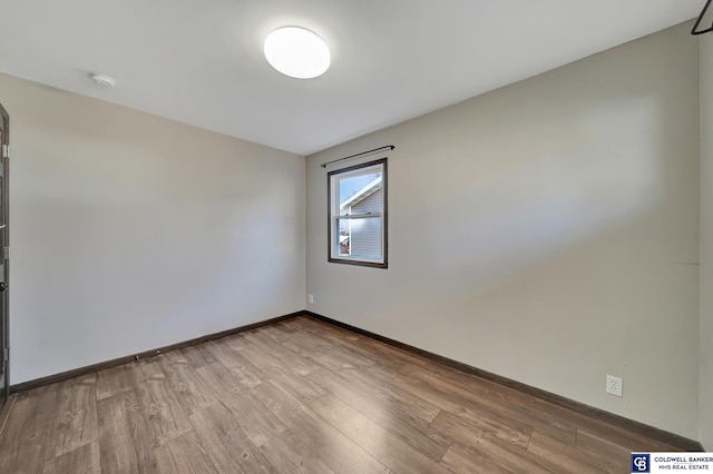 spare room featuring light hardwood / wood-style floors