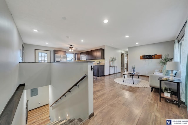 stairs with ceiling fan and wood-type flooring