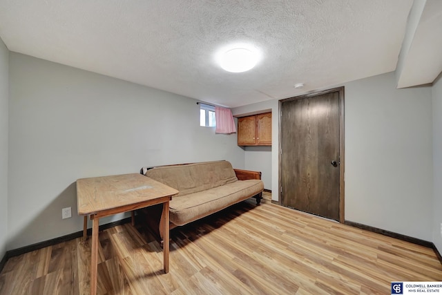 sitting room with light hardwood / wood-style floors and a textured ceiling