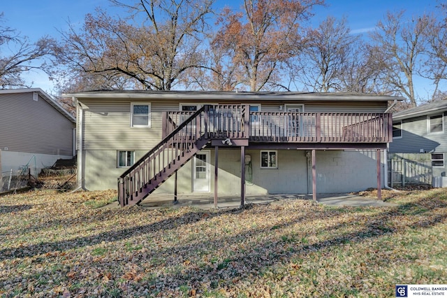 rear view of property with a yard and a wooden deck