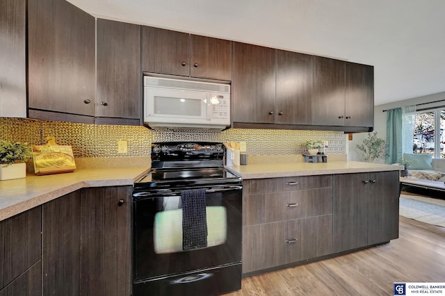 kitchen with black range with electric stovetop, dark brown cabinetry, light hardwood / wood-style flooring, and decorative backsplash