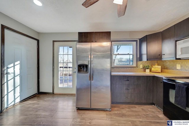 kitchen with black electric range oven, stainless steel refrigerator with ice dispenser, light hardwood / wood-style flooring, decorative backsplash, and dark brown cabinets