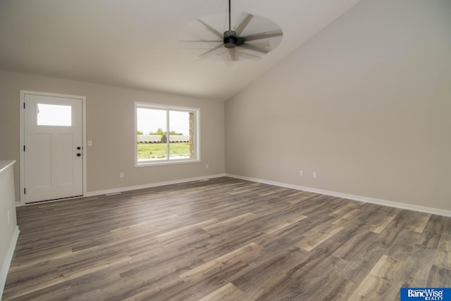 interior space with ceiling fan, lofted ceiling, and dark hardwood / wood-style flooring