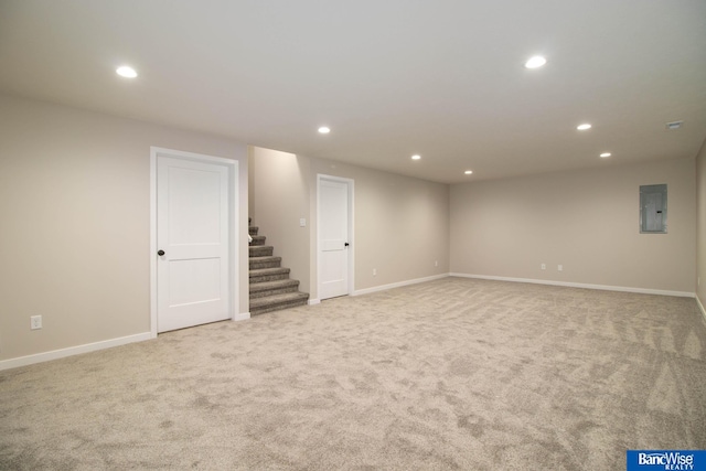 basement featuring light carpet and electric panel