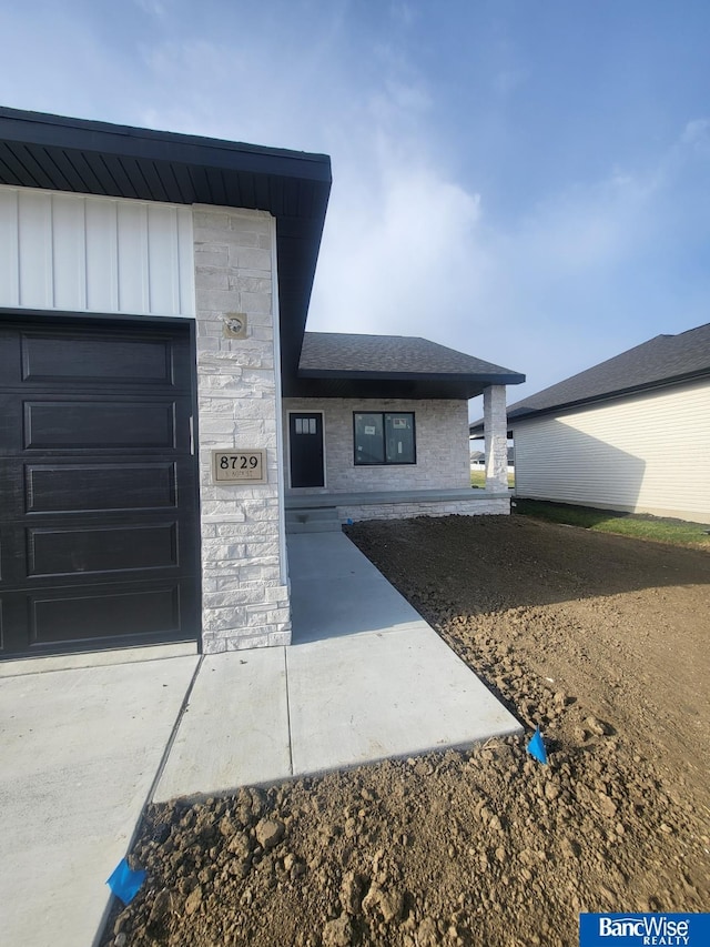 view of exterior entry with a garage