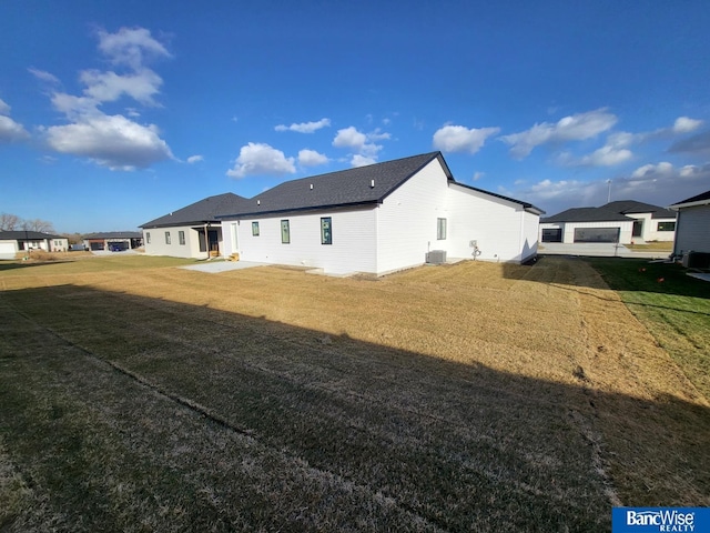 back of house featuring a patio, central AC, and a lawn