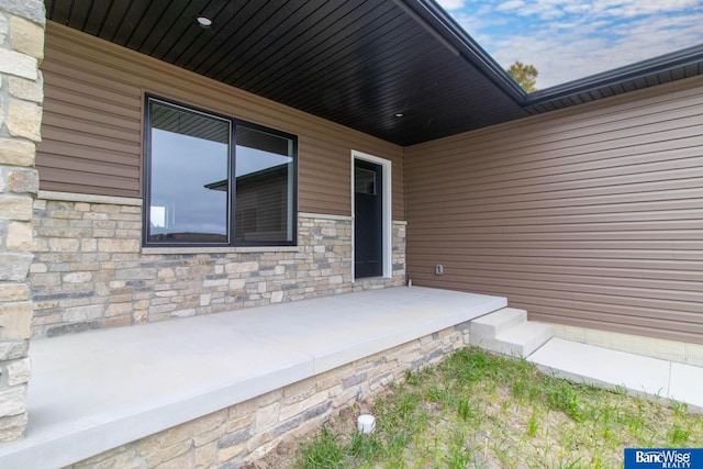 doorway to property with a patio area