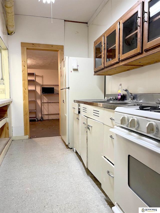 kitchen with white gas stove and sink