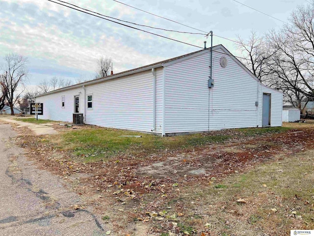 view of side of property featuring central AC