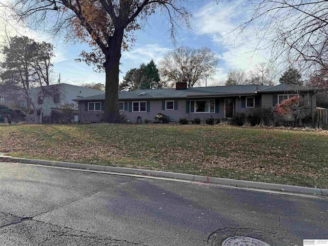 ranch-style home with a front yard