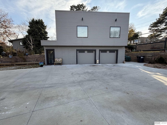 view of home's exterior featuring a garage and central AC unit