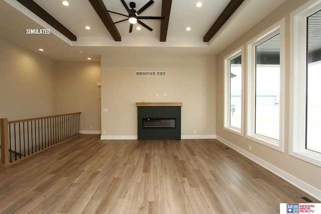 unfurnished living room with beamed ceiling, light hardwood / wood-style floors, and ceiling fan