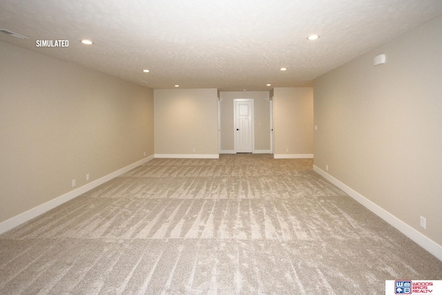 carpeted empty room with a textured ceiling