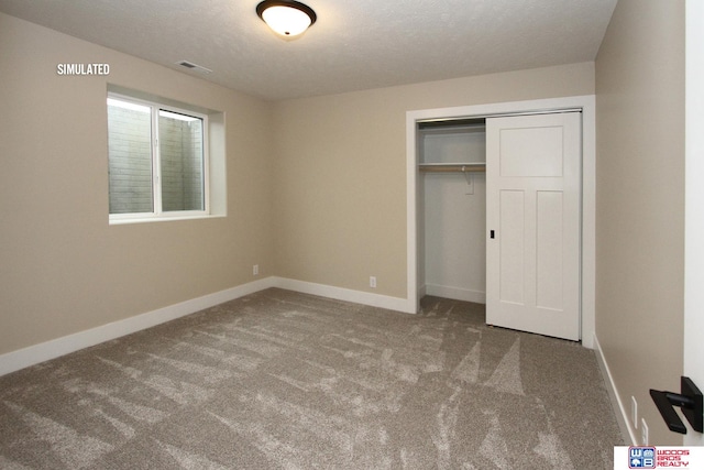 unfurnished bedroom with a closet, carpet floors, and a textured ceiling