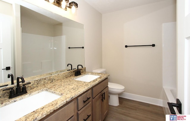 full bathroom with shower with separate bathtub, vanity, hardwood / wood-style flooring, and toilet