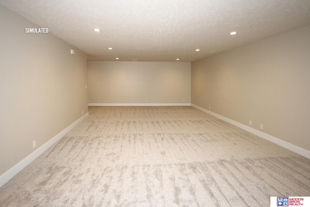 carpeted spare room with a textured ceiling