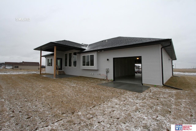 rear view of house featuring a garage