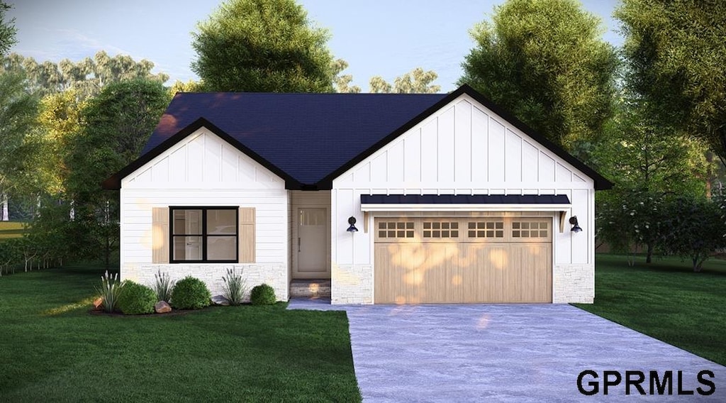 modern inspired farmhouse with a garage and a front lawn