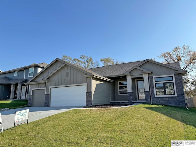 craftsman-style home featuring a garage and a front lawn