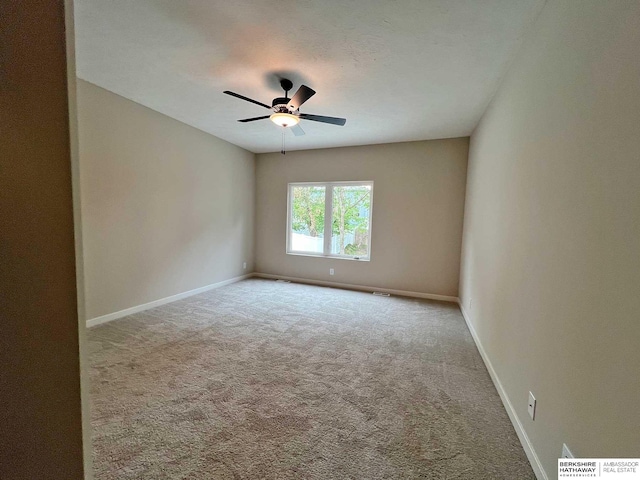 carpeted empty room featuring ceiling fan