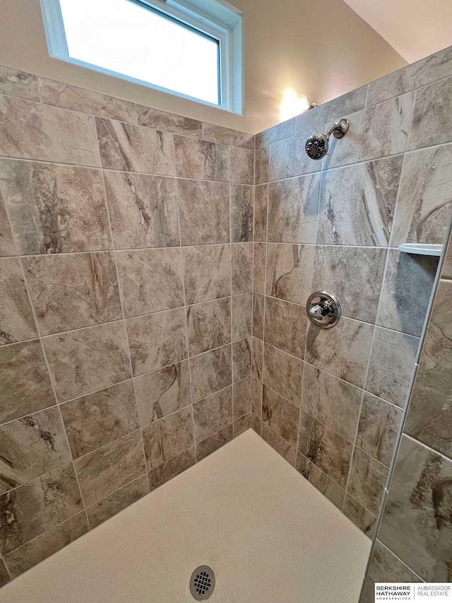 bathroom with a tile shower