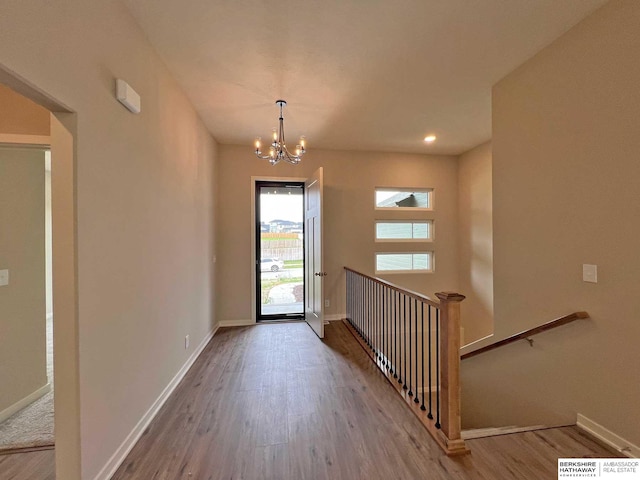 foyer with hardwood / wood-style floors and an inviting chandelier