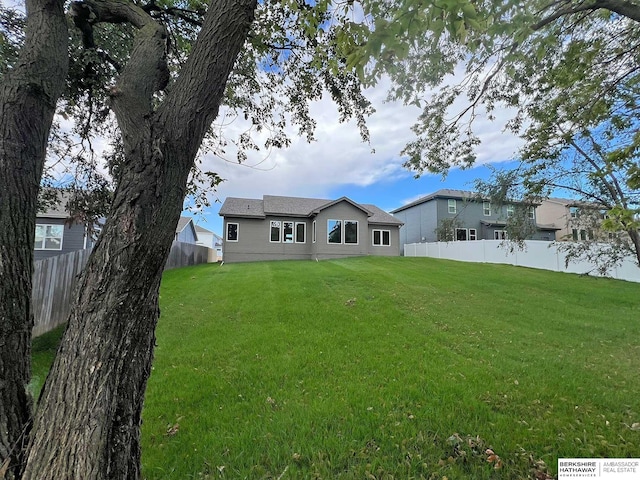 rear view of property featuring a yard