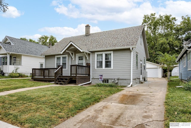 bungalow-style house featuring an outbuilding, a front yard, and a garage