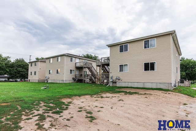 rear view of house with a yard and a deck