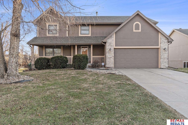 view of front of property featuring covered porch, a front yard, and a garage