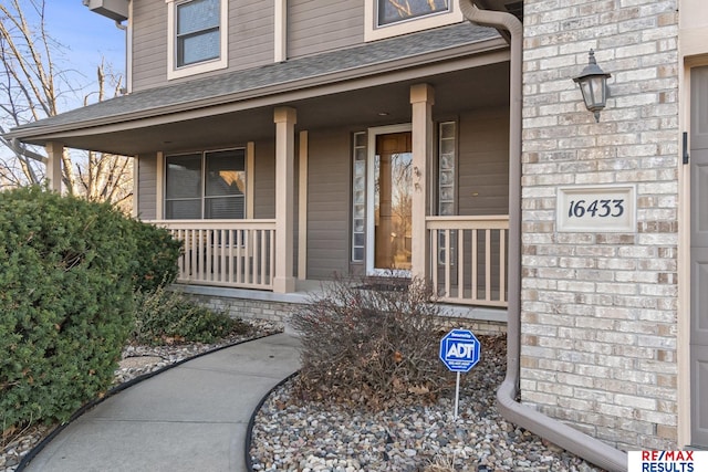 doorway to property featuring covered porch