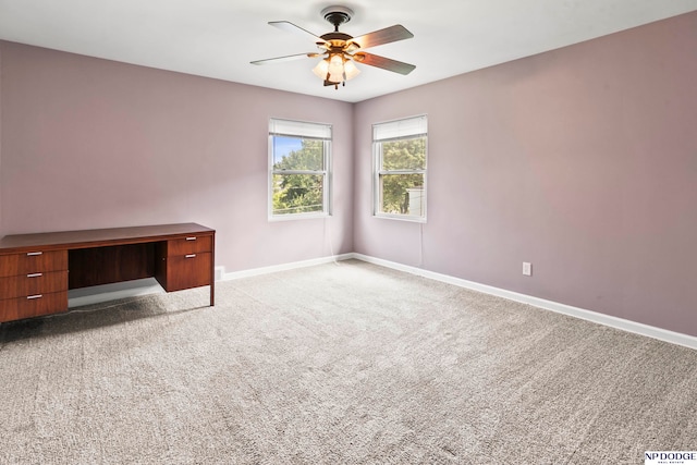 empty room with ceiling fan and light colored carpet