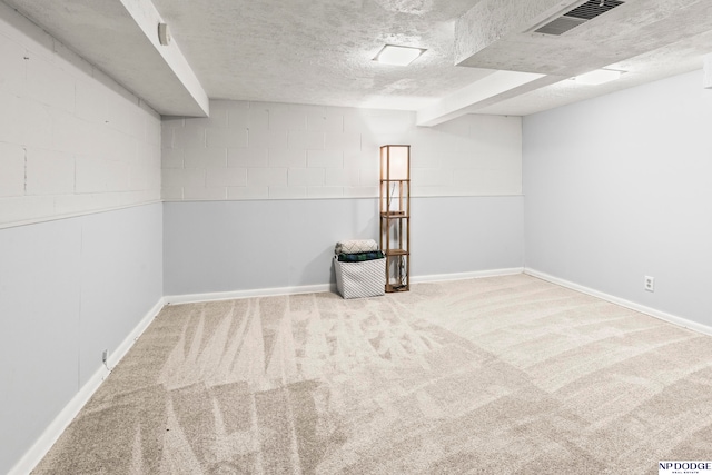 carpeted spare room featuring a textured ceiling