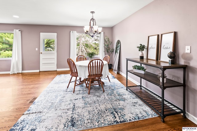 dining space featuring a chandelier and wood-type flooring